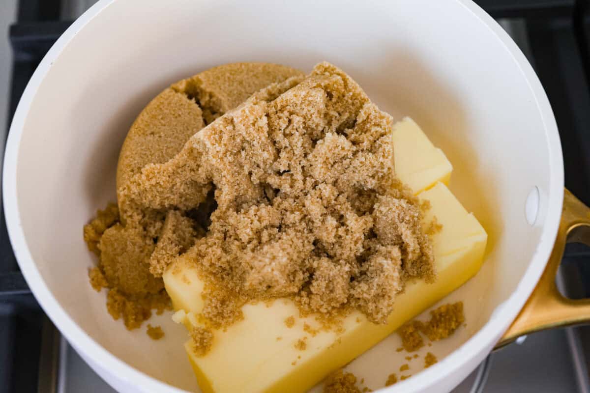 S'mores crack is a quick way to enjoy the classic s'more experience without a campfire. Featuring a buttery graham cracker crust, rich melted chocolate, and toasted marshmallows, this treat will quickly become a family favorite. Overhead shot of a bowl with two sticks of butter covered with a pile of brown sugar.