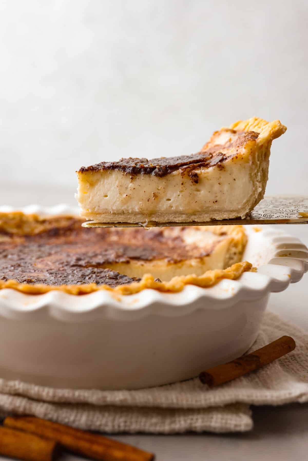 Sugar cream pie, or Hoosier pie, is a creamy, delicious treat with deep roots in the Midwest, especially in Indiana. You can top it however you like, serve it warm, at room temperature, or even chilled. Give this simple recipe a go. I know youโll love it! Side shot slice of sugar cream pie being lifted from pie pan.