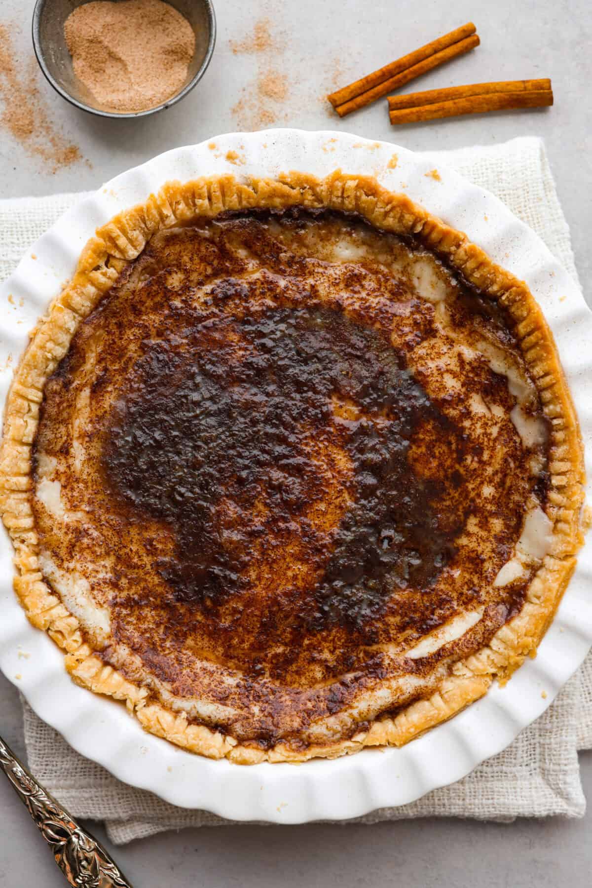 Sugar cream pie, or Hoosier pie, is a creamy, delicious treat with deep roots in the Midwest, especially in Indiana. You can top it however you like, serve it warm, at room temperature, or even chilled. Give this simple recipe a go. I know youโll love it! Overhead shot of completed sugar cream pie.