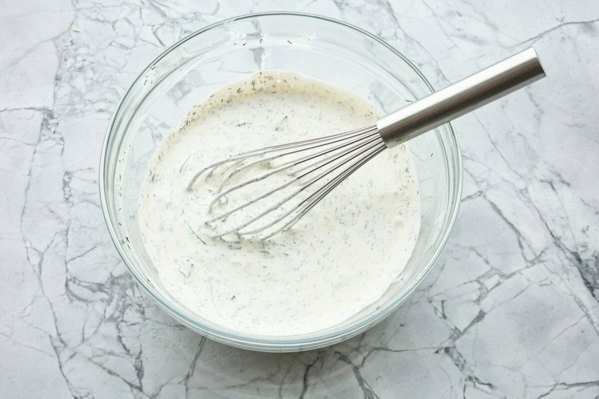 Tuna pasta salad is a perfect protein-packed lunch or side dish! It combines tuna, veggies, and pasta then gets tossed in a creamy dill dressing. Second photo of the dressing mixed together.