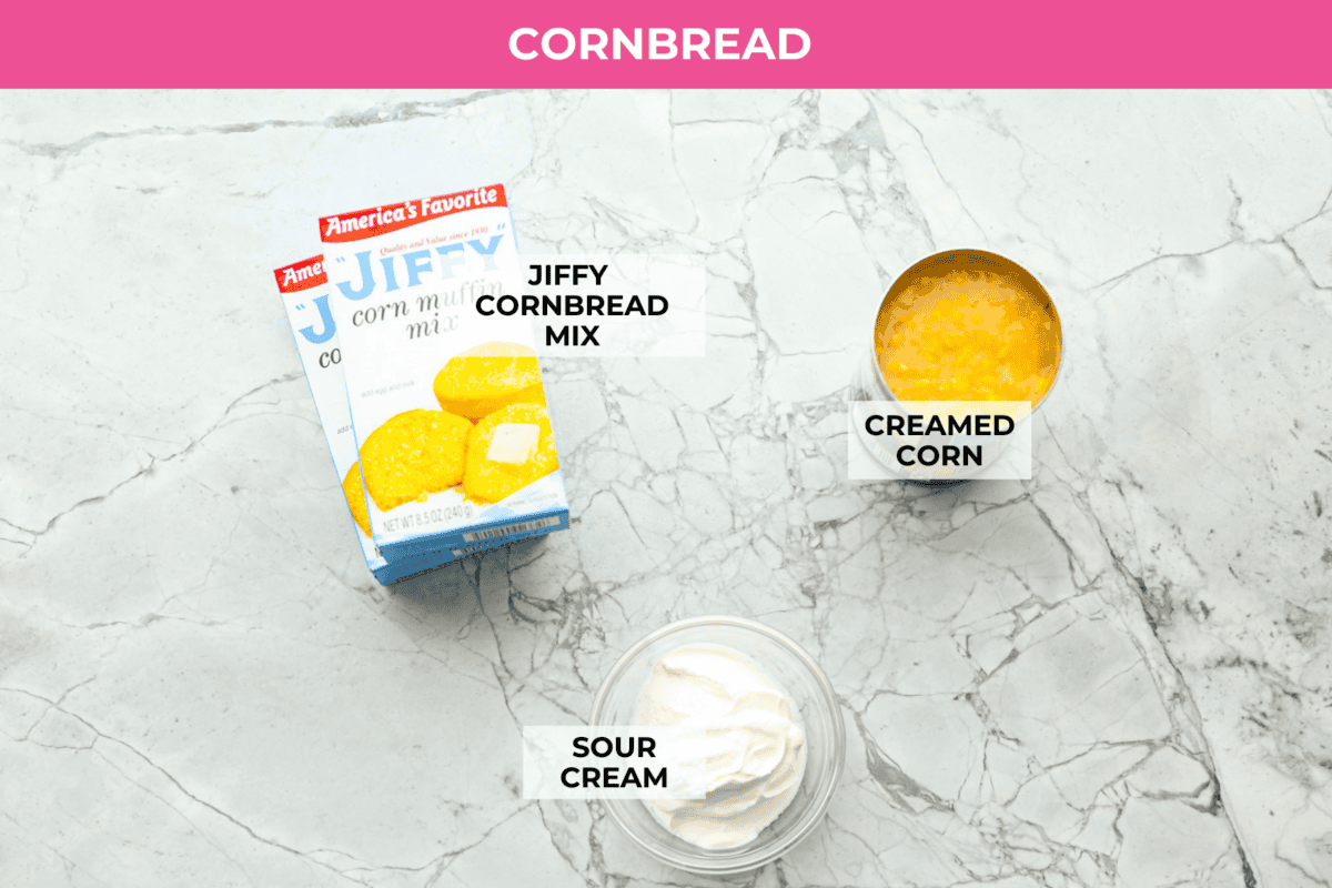 Cowboy Cornbread Casserole is a flavorful, comforting meal that's so easy to make. Seasoned ground beef, corn, pinto beans, and Rotel tomatoes are layered with shredded cheddar cheese and a cornbread topping for a winning dinner! Overhead shot of labeled cornbread ingredients.