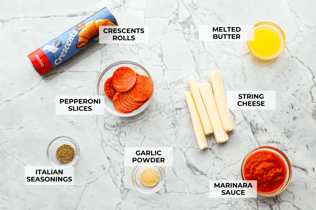 Pizza Stuffed Crescent Rolls areย loaded with gooey mozzarella cheese and pepperoni. Serve with warm marinara for dipping! Overhead shot of labeled ingredients.