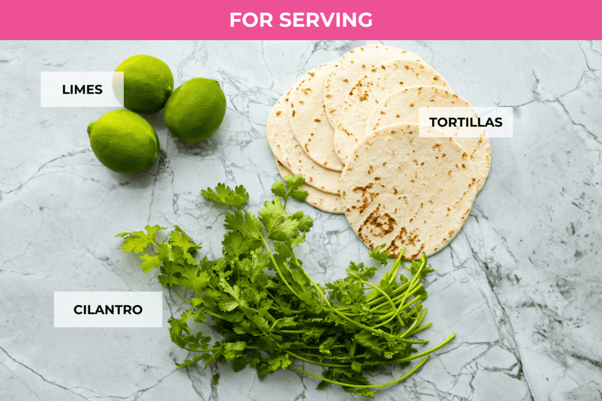 Sheet pan steak fajitas are beautiful and bursting with flavor. Easy to throw together on busy weeknights, they feature tender steak and crisp, colorful vegetables in every bite. You will definitely want to add this to your weekly meal planning! Overhead shot of labeled serving ingredients.