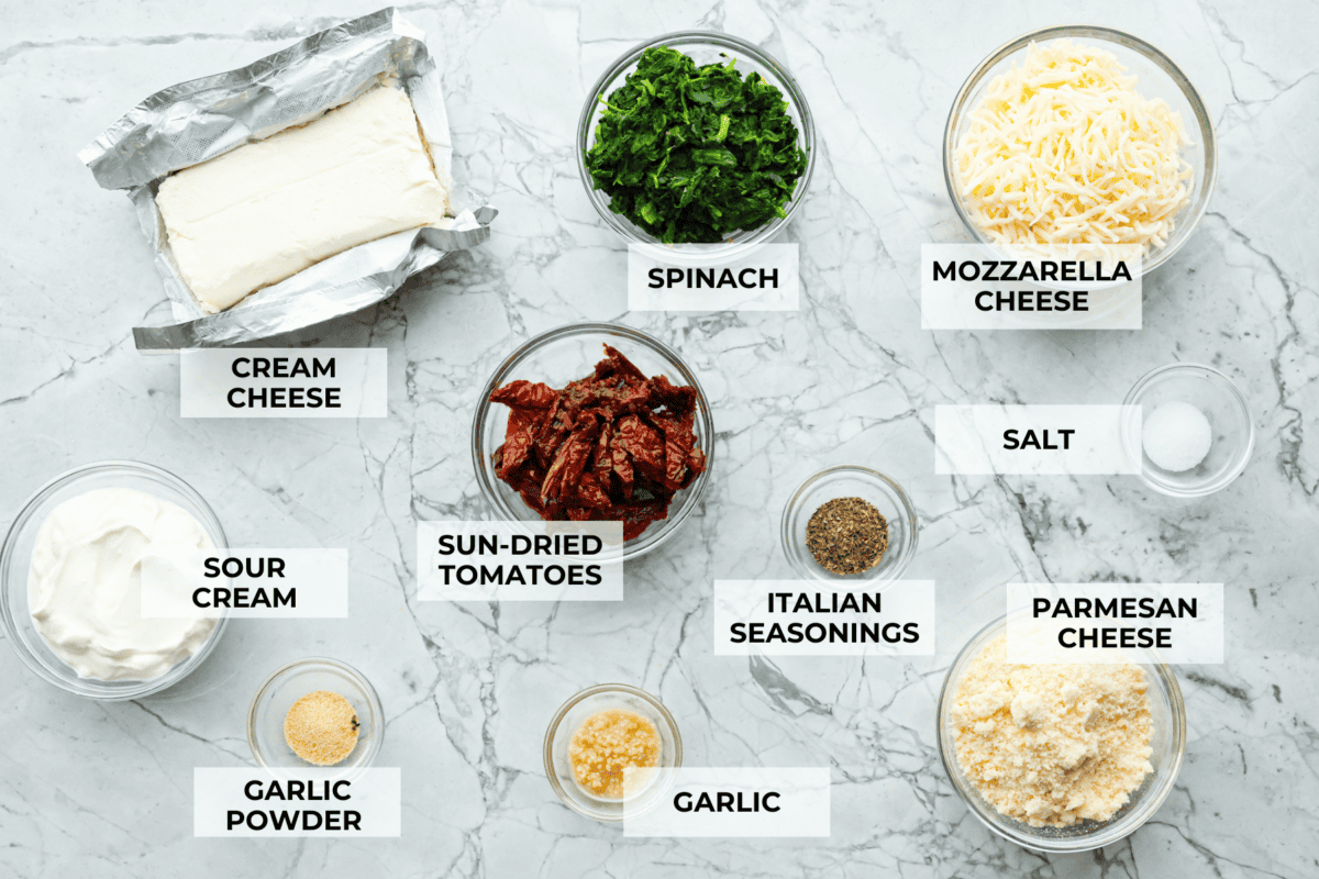 There's a new appetizer in town, and this creamy Tuscan dip won everyone's hearts! The combination of cheeses, garlic, spinach, and sun-dried tomatoes creates an addicting dip you’ll want to bring to all of your gatherings! Ingredients listed to make creamy Tuscan dip.