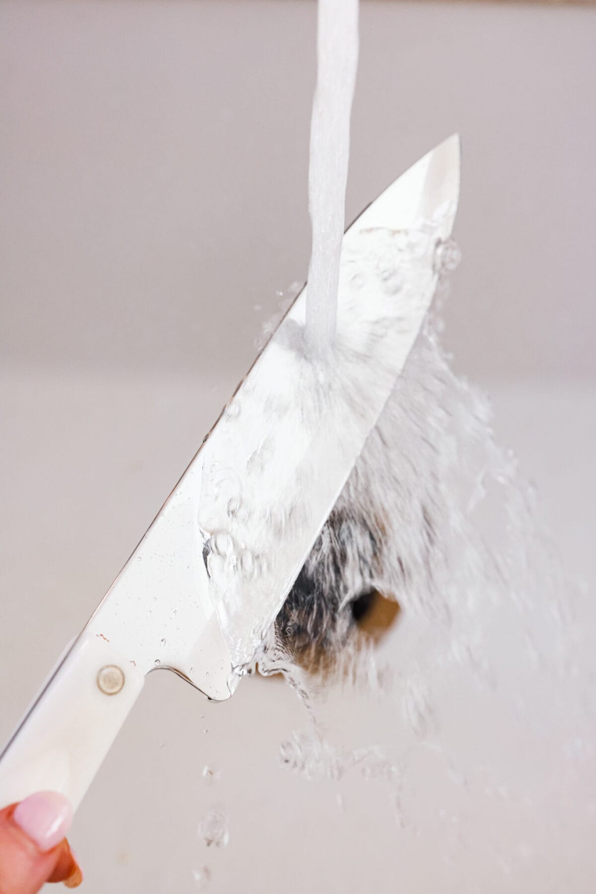 Cheesecake is my absolute FAVORITE dessert! I have perfected my method and I can't wait to teach you how to make cheesecake in this ultimate step-by-step guide. You're on your way to being a cheesecake-making pro! First photo of hot water running on a knife.