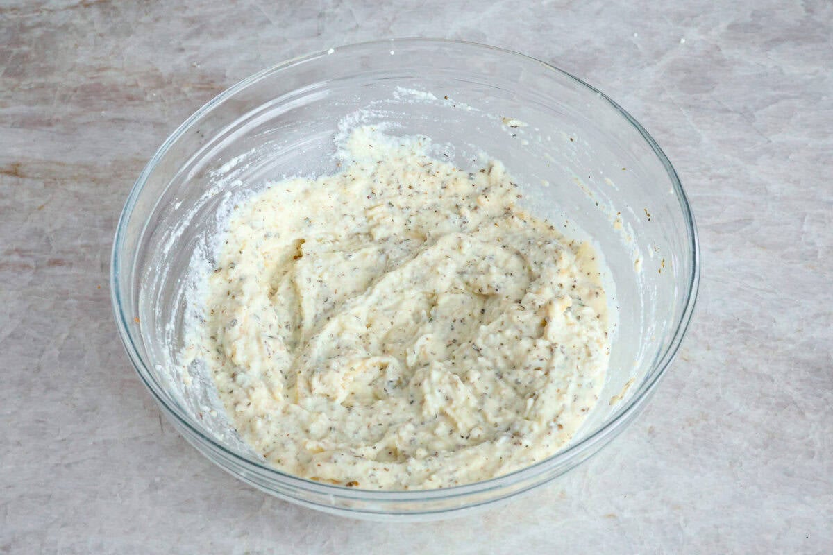 Angle shot of cheese filling mixture in glass bowl.
