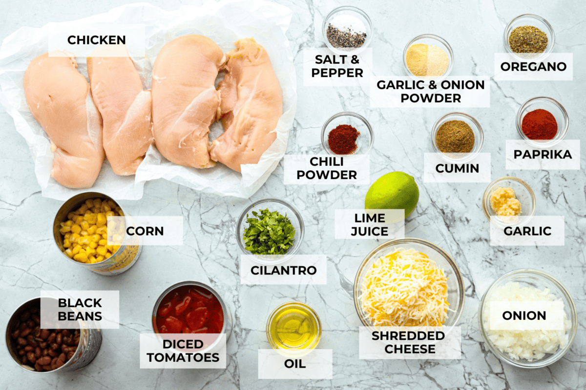 This cowboy chicken recipe is packed with bold flavors. The chicken is seared with lots of vibrant seasonings, surrounded by corn, black beans, and fire-roasted tomatoes, all smothered in melty cheese. Your family will love this quick meal that is ready in just 35 minutes! Overhead shot of labeled ingredients.