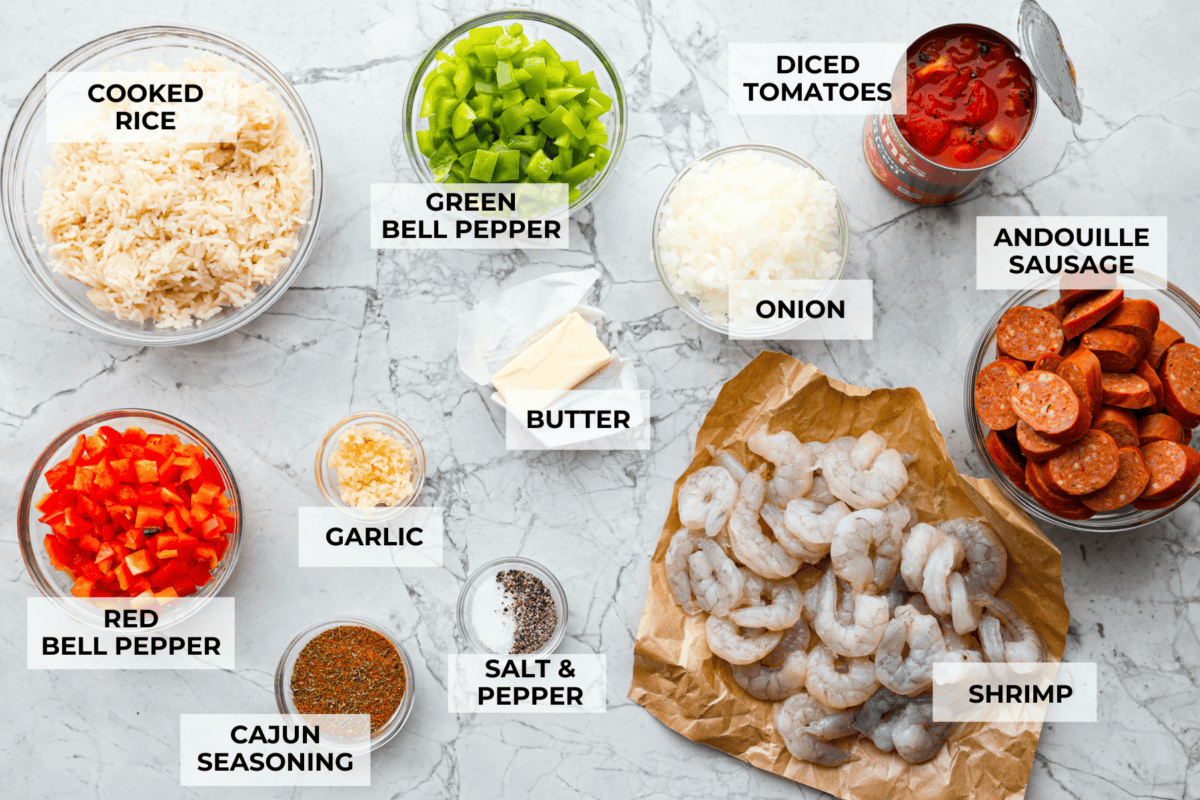 This delicious Louisiana Casserole has become an instant favorite in our house! It has all of the delicious flavors of a jambalaya in an easy-to-make casserole. Tasty andouille sausage, shrimp, veggies, rice and cajun seasoning come together for a complete meal on the table in just 40 minutes! Overhead shot of labeled casserole ingredients.