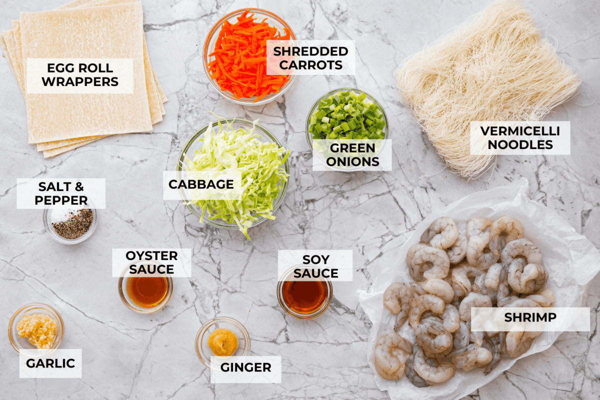 Crispy outside with a warm, flavorful filling, these Shrimp Egg Rolls are beyond delicious! They're packed with a mix of vermicelli noodles, sautéed veggies, shrimp and plenty of flavorings, then fried till crunchy and golden brown. Serve them as an appetizer, a light main or party side dish! Overhead shot of labeled ingredients.