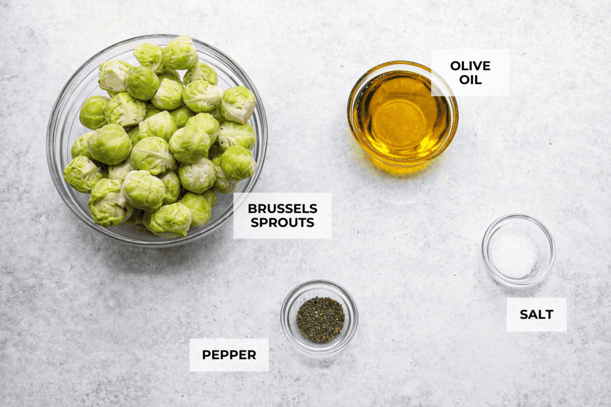Irresistibly crispy Smashed Brussels Sprouts areย simple to make, loaded with delicious flavor, and have the best crunchy texture. These pair well with almost any protein and will definitely upgrade your side dish game! Overhead shot of labeled ingredients.