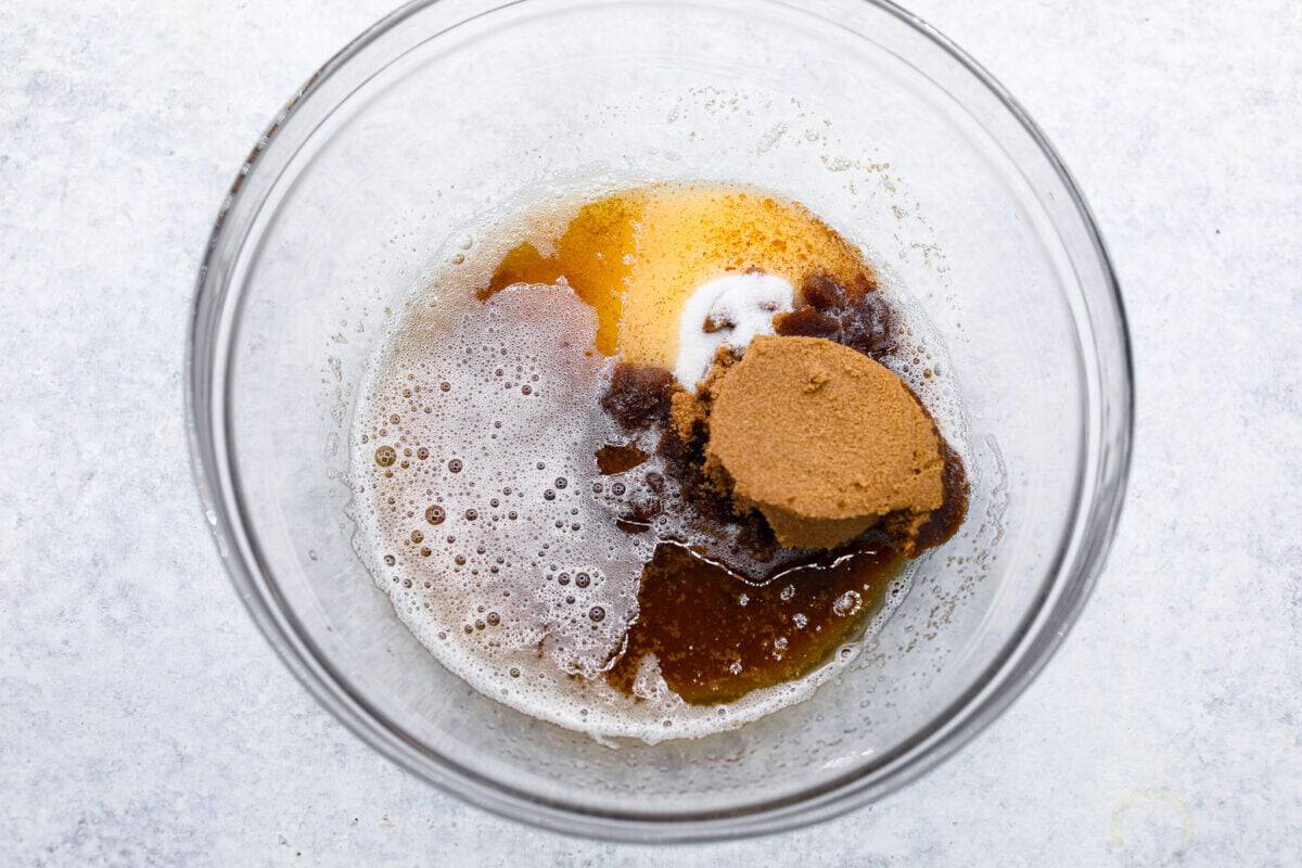 Browned Butter Sugar Cookies are irresistibly thick and chewy with rich flavor, thanks to the addition of browned butter. Even more delicious than the classic, and there's no need to chill the dough! Overhead shot of brown sugar, granulated sugar, browned butter in a glass bowl.