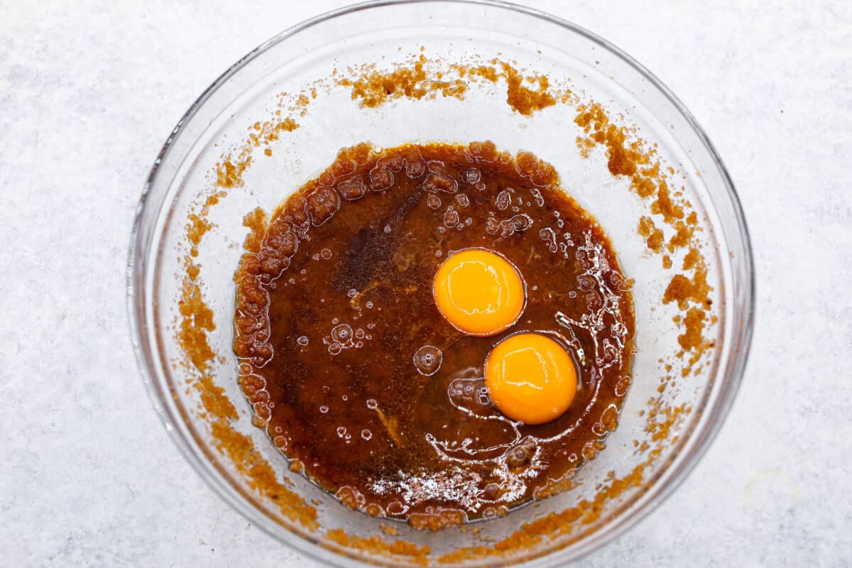 Browned Butter Sugar Cookies are irresistibly thick and chewy with rich flavor, thanks to the addition of browned butter. Even more delicious than the classic, and there's no need to chill the dough! Overhead shot of sugar and butter mixture with egg and egg yolk on top.