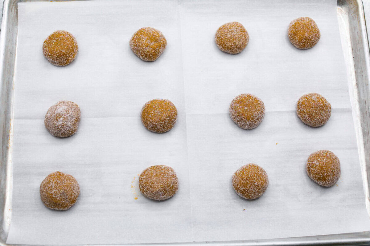 Browned Butter Sugar Cookies are irresistibly thick and chewy with rich flavor, thanks to the addition of browned butter. Even more delicious than the classic, and there's no need to chill the dough! Overhead shot of cookie dough balls spread evenly on a cookie sheet.