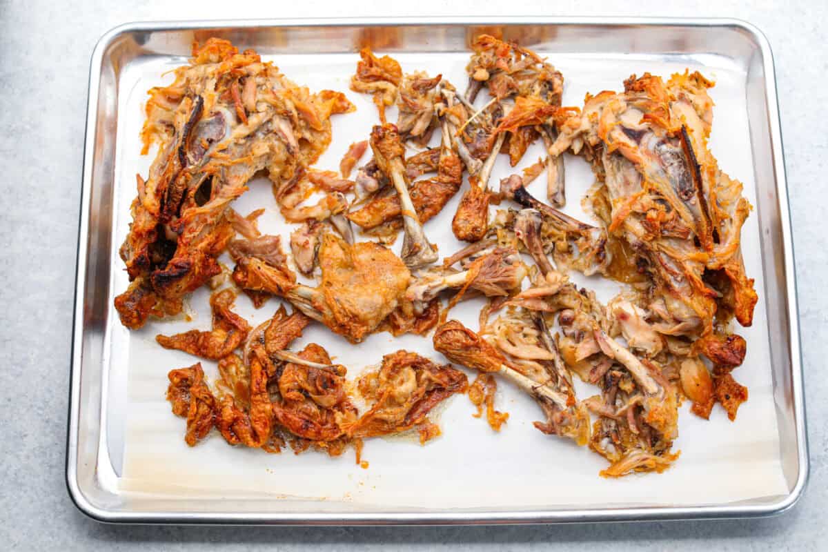 Learn how to make homemade bone broth with all of my top tips and tricks! This easy recipe is a simple combination of wholesome, nutritious ingredients. It's freezer-friendly and great for using in a variety of recipes, from soups, sauces and gravies to casseroles and rice. Overhead sho too chicken carcass spread out on a cookie sheet with parchment paper.