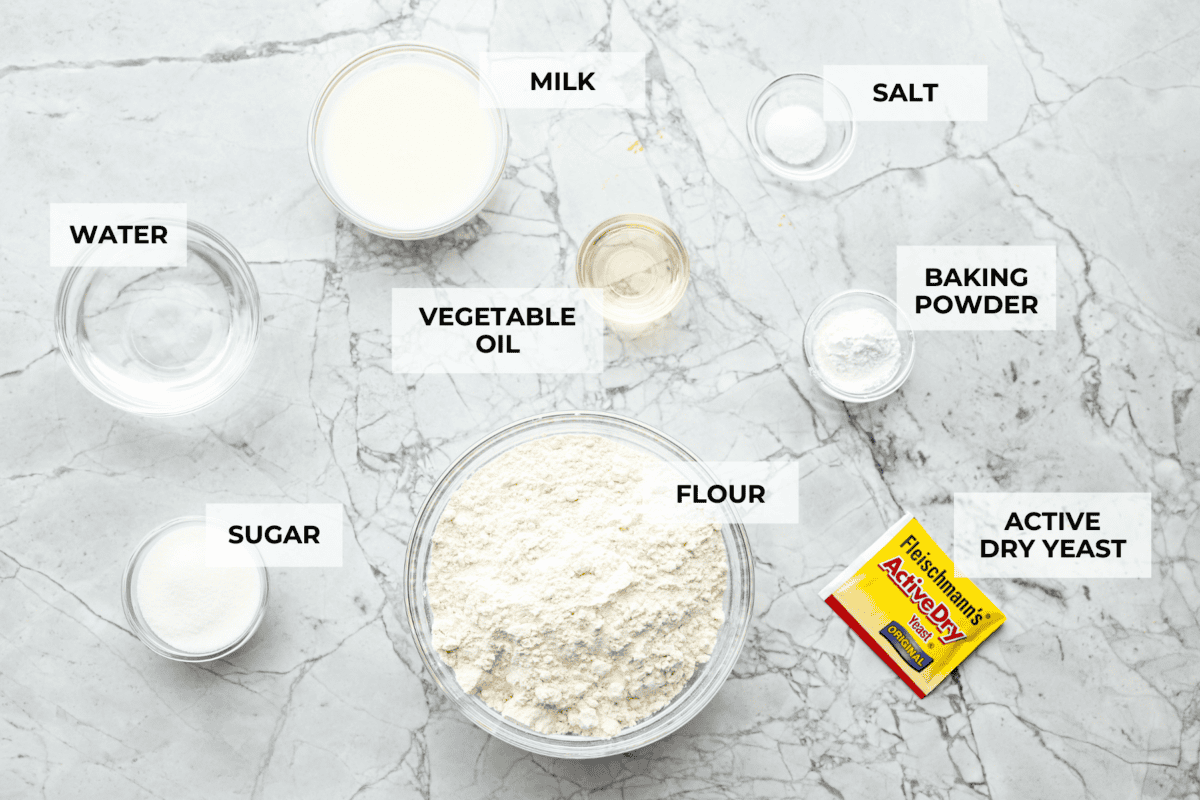 Bao Buns, or Baozi, are soft, pillowy buns made from a slightly sweet dough. They originate from China and are served with different types of fillings. You can enjoy them as a snack, as a side, or with dim sum. Overhead shot of labeled ingredients.