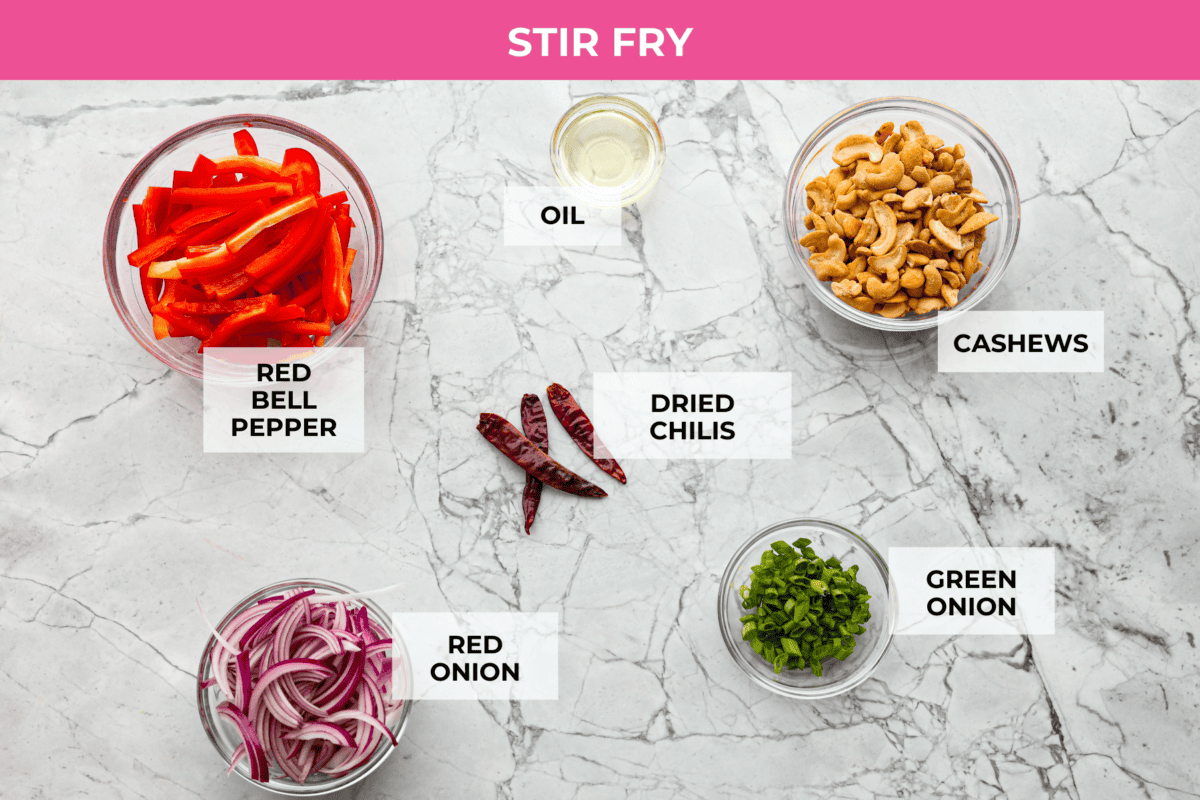 Dragon Chicken is a spicy and flavorful dish featuring tender breaded chicken stir-fried with vegetables and coated in a rich, tangy, and slightly sweet sauce. It's a crowd favorite for those who enjoy a fiery twist on the classic stir-fry! Overhead shot of stir fry ingredients.
