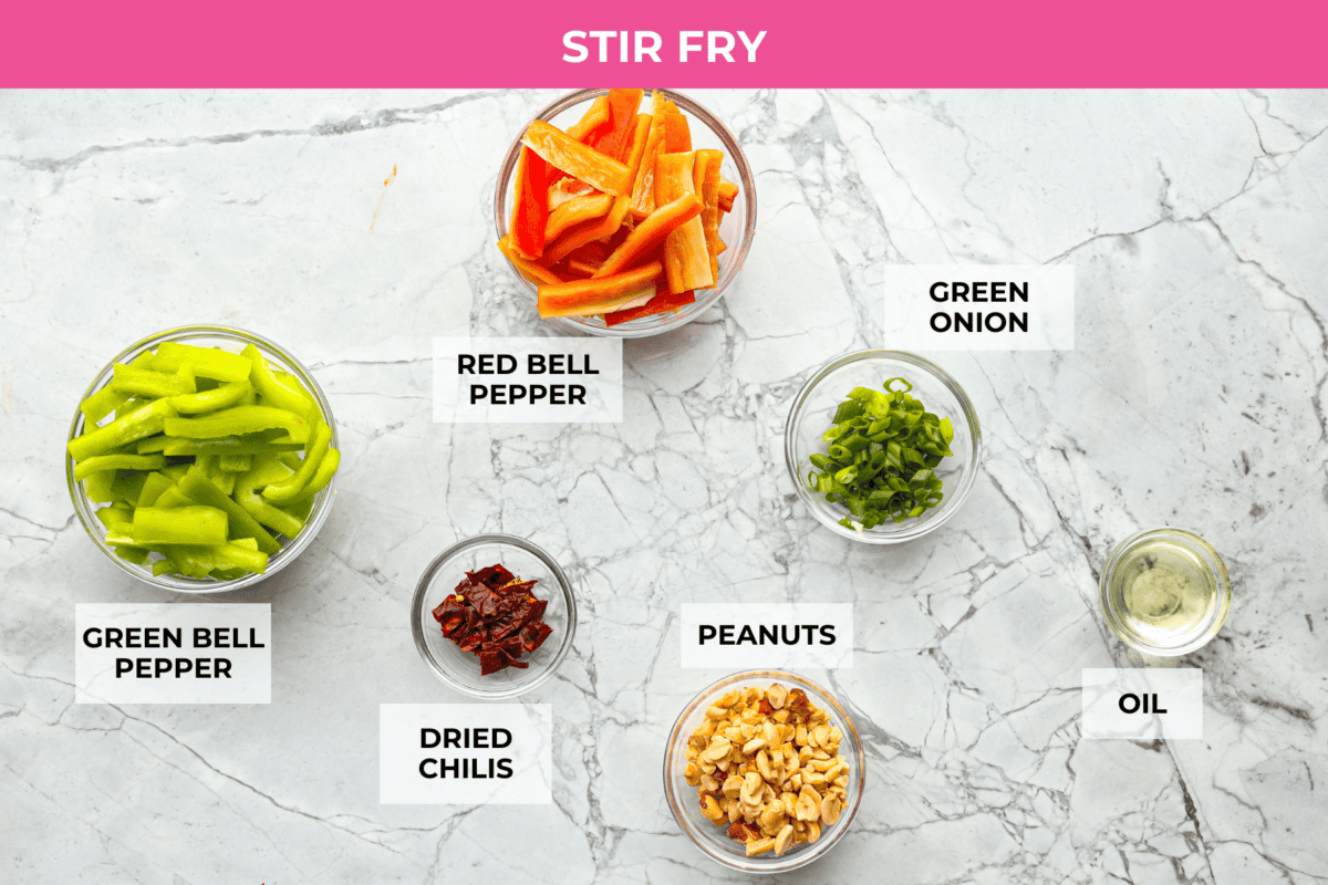 Kung Pao Beef is just like your favorite takeout but way tastier! This dish is loaded with flavor and so easy to make. Tender, marinated beef is stir-fried with veggies in a tangy, spicy Asian sauceย for an unforgettable meal! Overhead shot of labeled stir fry ingredients.