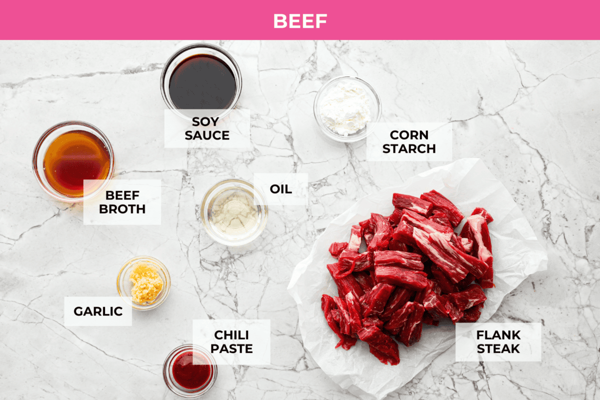 Kung Pao Beef is just like your favorite takeout but way tastier! This dish is loaded with flavor and so easy to make. Tender, marinated beef is stir-fried with veggies in a tangy, spicy Asian sauceย for an unforgettable meal! Overhead shot of labeled beef ingredients.