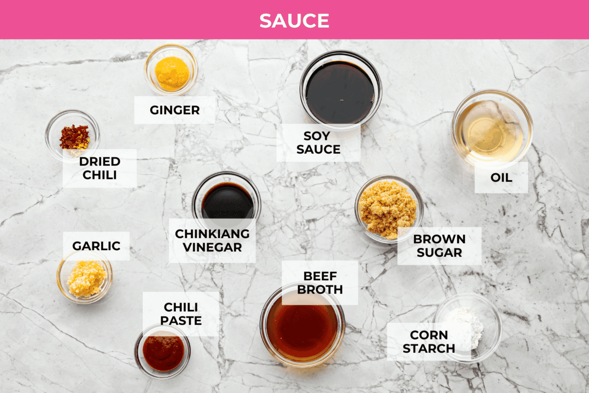Kung Pao Beef is just like your favorite takeout but way tastier! This dish is loaded with flavor and so easy to make. Tender, marinated beef is stir-fried with veggies in a tangy, spicy Asian sauceย for an unforgettable meal! Overhead shot of labeled sauce ingredients.
