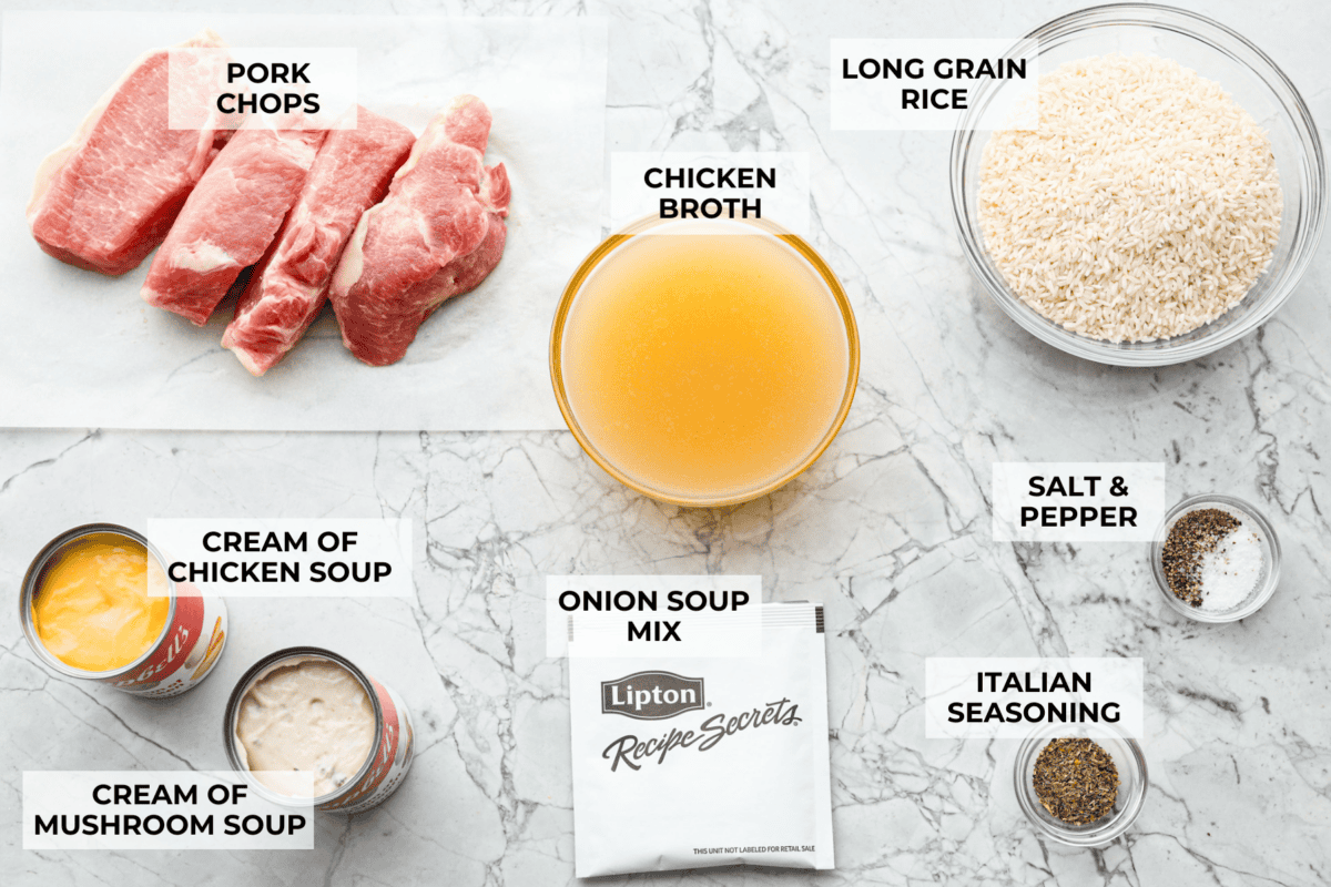 No Peek Pork Chops and Rice is comfort food at its best! Creamy, savory riceย and tender pork chops are baked together in the same pan with less than 10 minutes of prep. This dish is a go-to for busy weeknights and is perfect when you need a tasty meal without much hassle! Overhead shot of labeled ingredients.