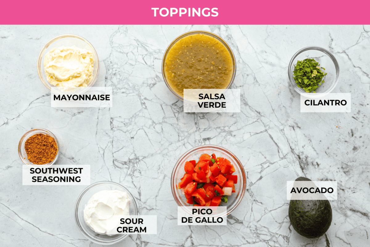 Homemade Sweet Corn Tamale Cakes are an explosion of delicious flavor in every bite! With this easy recipe you can bring this Cheesecake Factory favorite right to your own kitchen. Add the signature topping to really take these to the next level! Overhead shot of labeled topping ingredients.