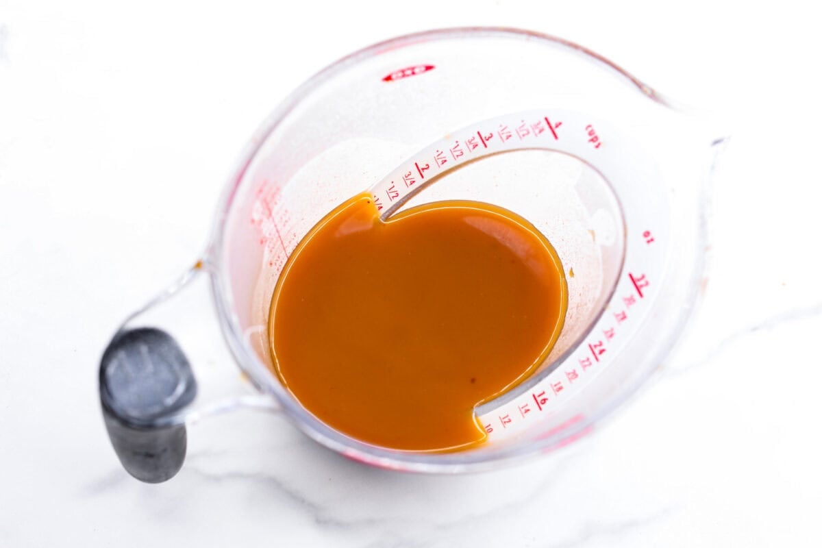 Thisย Harry Potterย Pumpkin Juice will transport you to a magical ride on the Hogwarts Express or eating lunch with your friends in the great hall. Bursting with warm, cozy fall flavor, you will love feeling part of the wizarding world of Harry Potter with this magical drink. Overhead shot of strained pumpkin juice in a measuring cup.