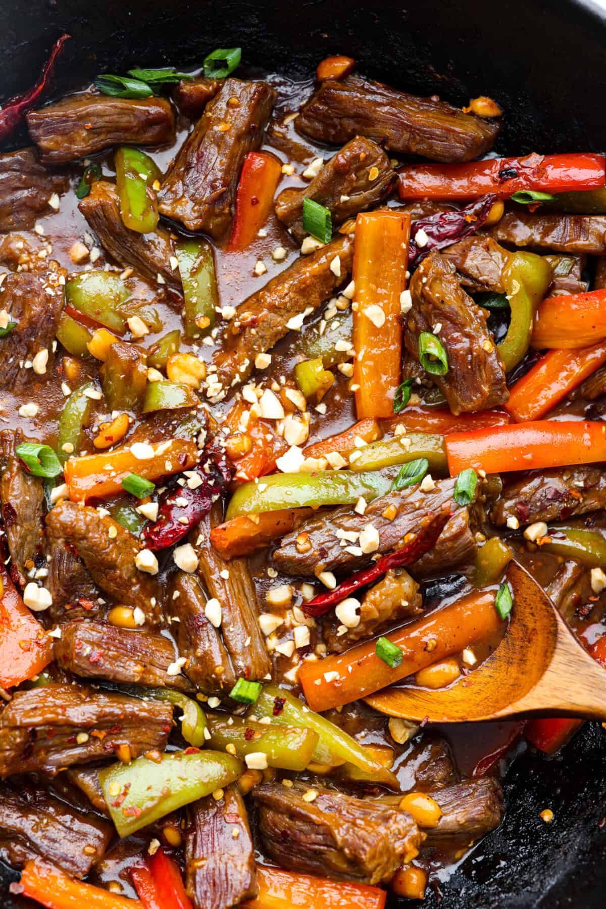 Kung Pao Beef is just like your favorite takeout but way tastier! This dish is loaded with flavor and so easy to make. Tender, marinated beef is stir-fried with veggies in a tangy, spicy Asian sauceย for an unforgettable meal! Close up shot of Kung Pao Beef.