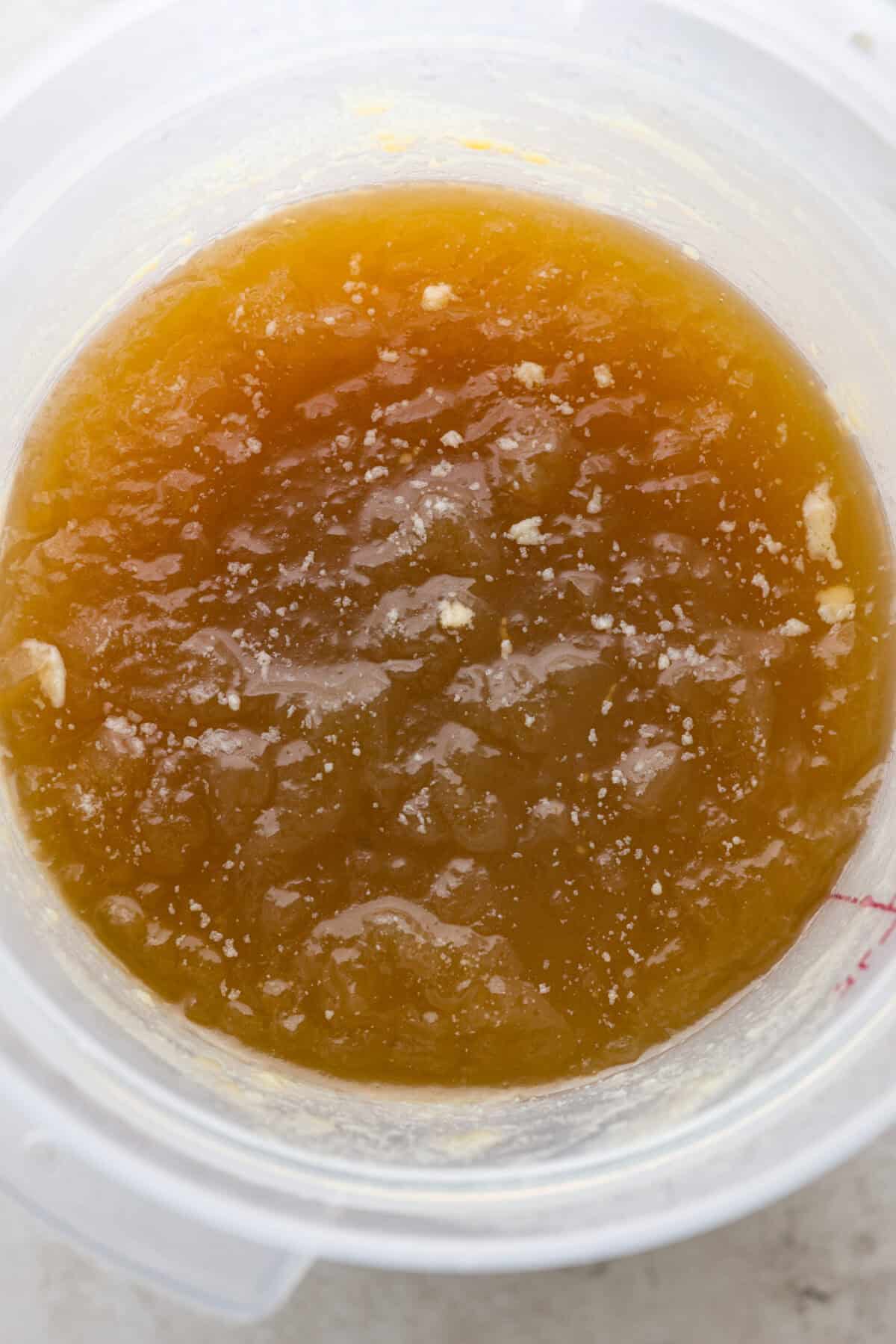 Learn how to make homemade bone broth with all of my top tips and tricks! This easy recipe is a simple combination of wholesome, nutritious ingredients. It's freezer-friendly and great for using in a variety of recipes, from soups, sauces and gravies to casseroles and rice. Overhead shot of gelatinized homemade bone broth.
