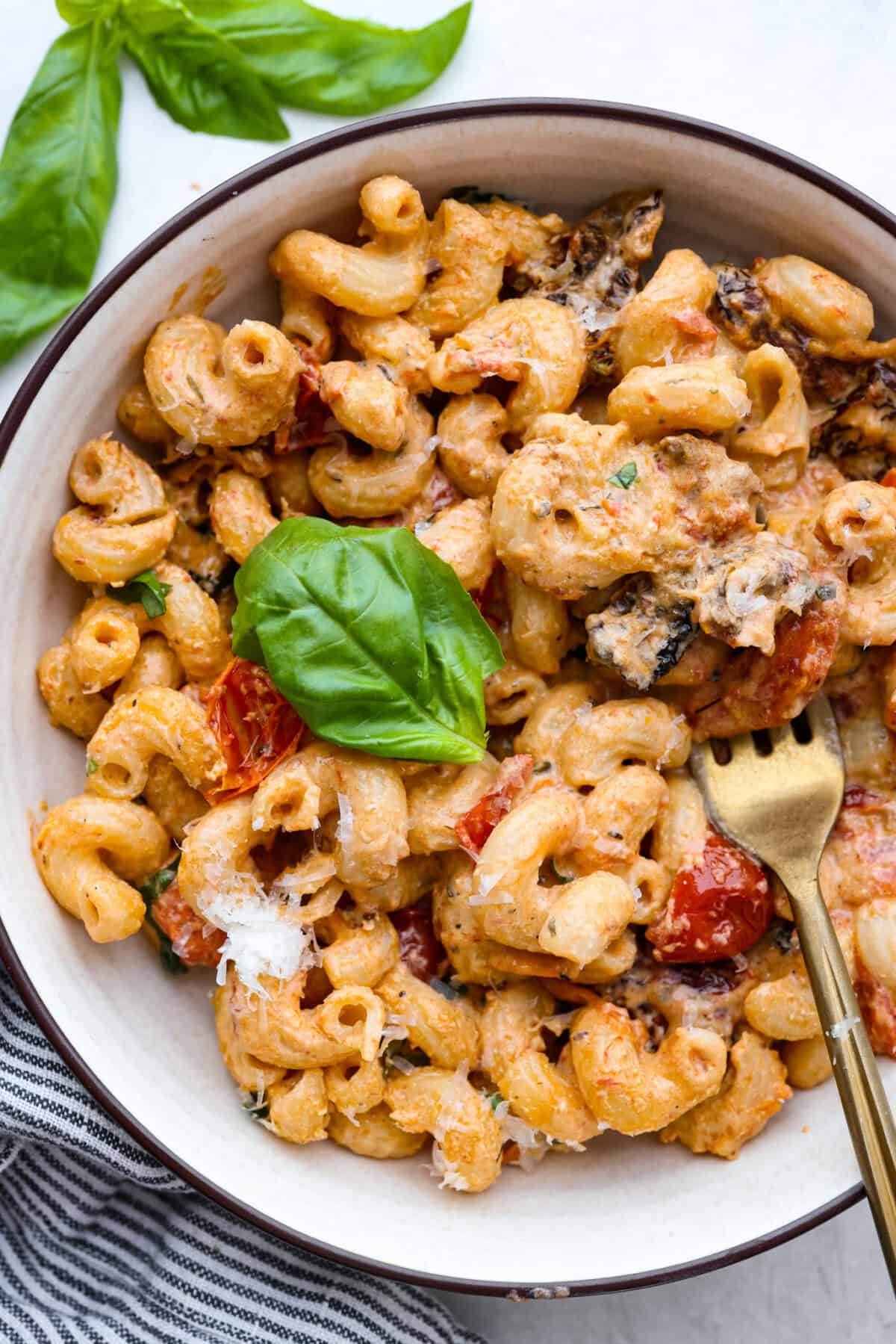 This Boursin pasta recipe has gone viral on social media. It's simple to make and packed with flavor! It's creamy with a distinct zingy bite from the Boursin cheese and sundried tomatoes. This dish screams flavor! It's anything but boring. Overhead shot of plated Boursin pasta.