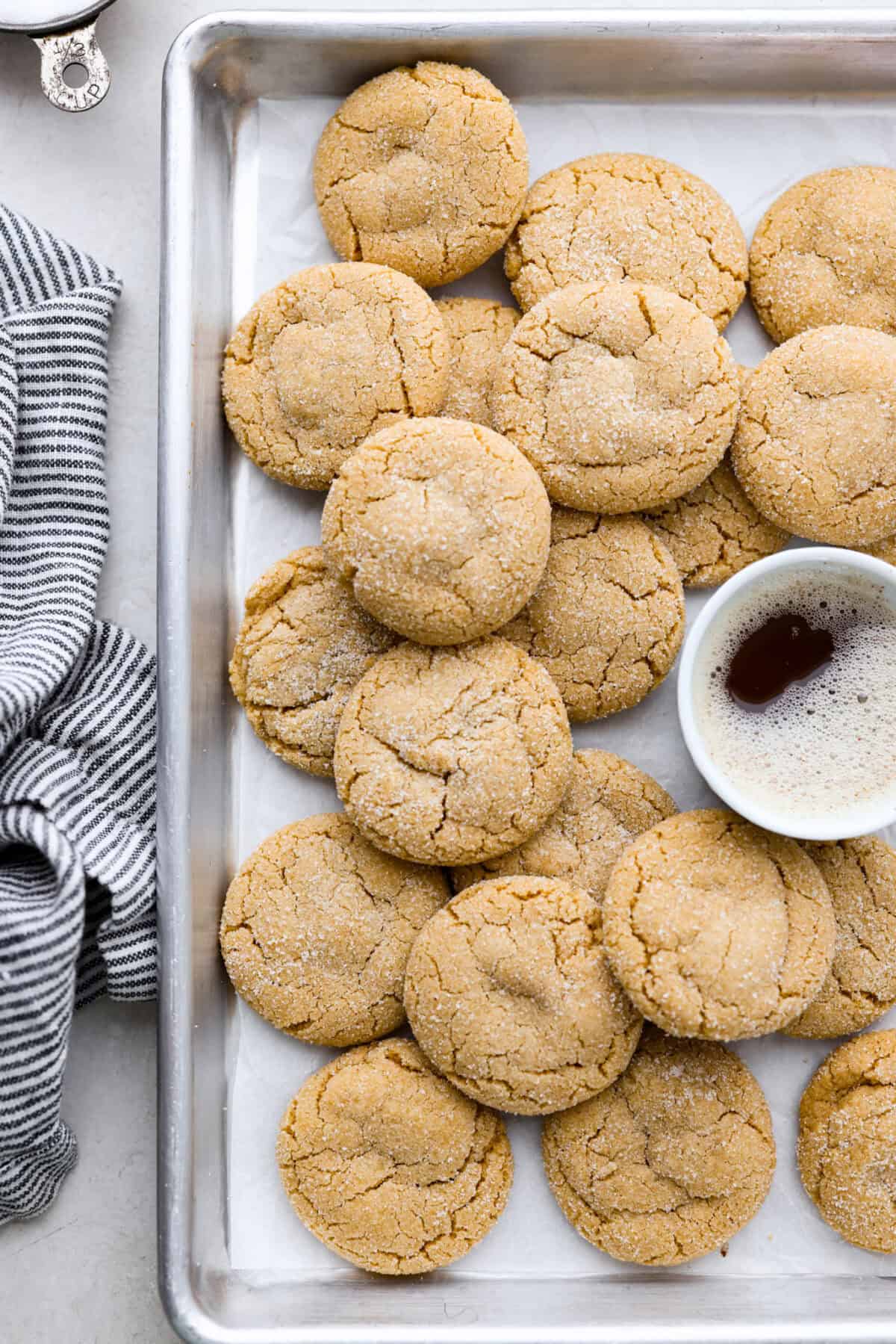 Browned Butter Sugar Cookies are irresistibly thick and chewy with rich flavor, thanks to the addition of browned butter. Even more delicious than the classic, and there's no need to chill the dough! Overhead shot of browned butter sugar cookies stacked on a cookie sheet.