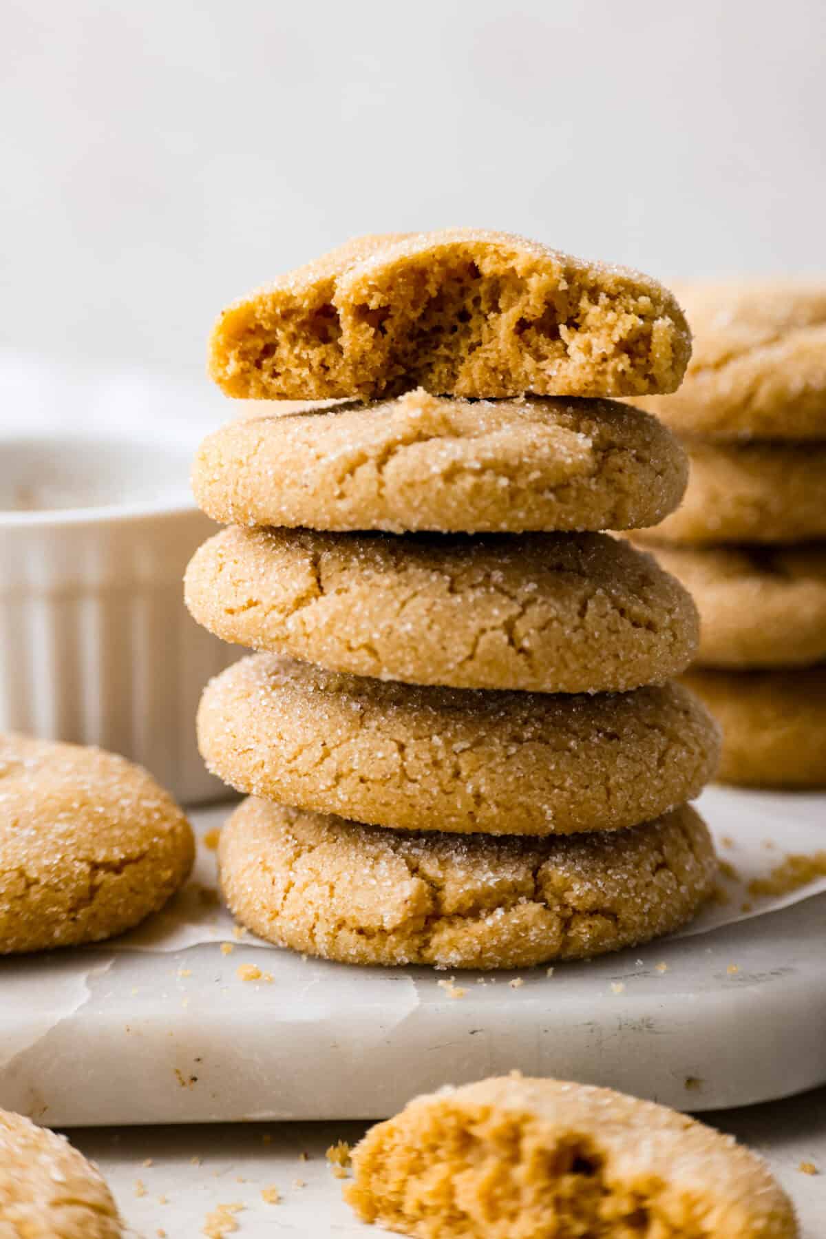 Browned Butter Sugar Cookies are irresistibly thick and chewy with rich flavor, thanks to the addition of browned butter. Even more delicious than the classic, and there's no need to chill the dough! Side shot of browned butter sugar cookies stacked on a marble cutting board.