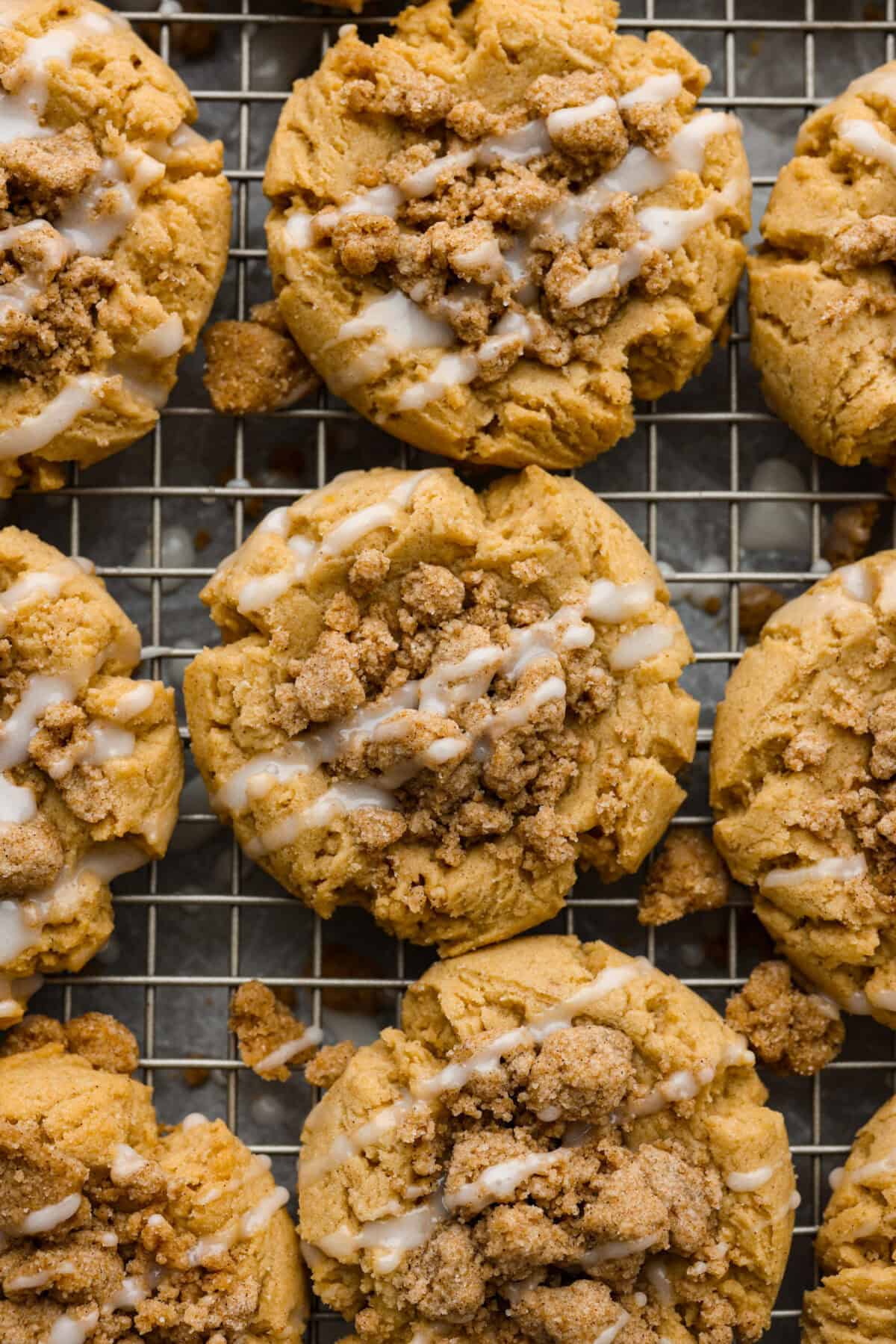 You will absolutely adore these Coffee Cake Cookies! They are loaded with that classic cinnamon sugar flavor, and the crumbly cinnamon streusel is to die for. It’s the perfect treat to enjoy at a special brunch, for the holidays, or a sweet treat for any night of the week. Close up shot of coffee cake cookies on a cooling rack.