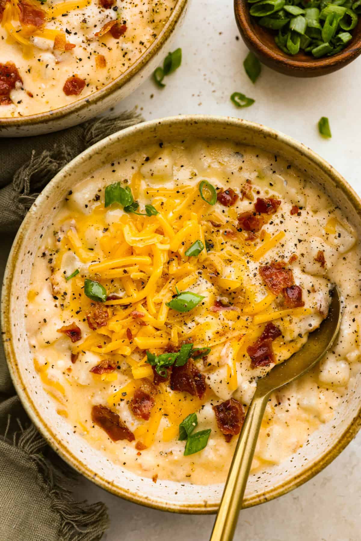 This crock pot crack potato soup is the best and easiest soup you will ever make! It's loaded with creamy cheese, potatoes, hearty chicken, and savory bacon, all seasoned to perfection! Your family will love smelling this cooking when they get home from school! They will like how it tastes even better! Overhead shot of plated crock pot crack potato soup in bowls.