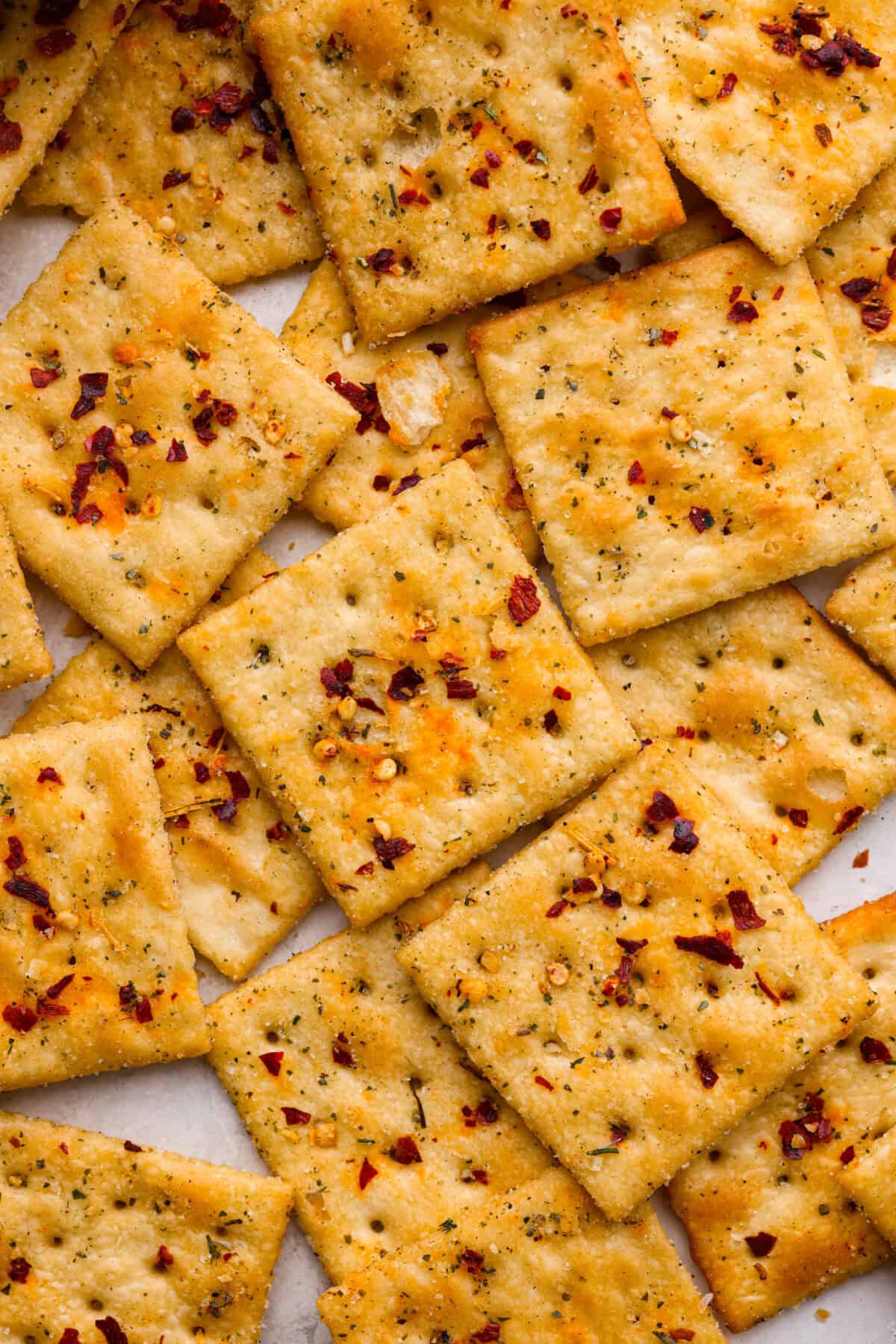 Get the party started with Fire Crackers! In this recipe, saltine crackers are transformed from something ordinary into something extraordinary with a flavorful blend of seasonings. They're easy to make and perfect for snacking on around the holidays (or anytime)! Close up shot of fire crackers.