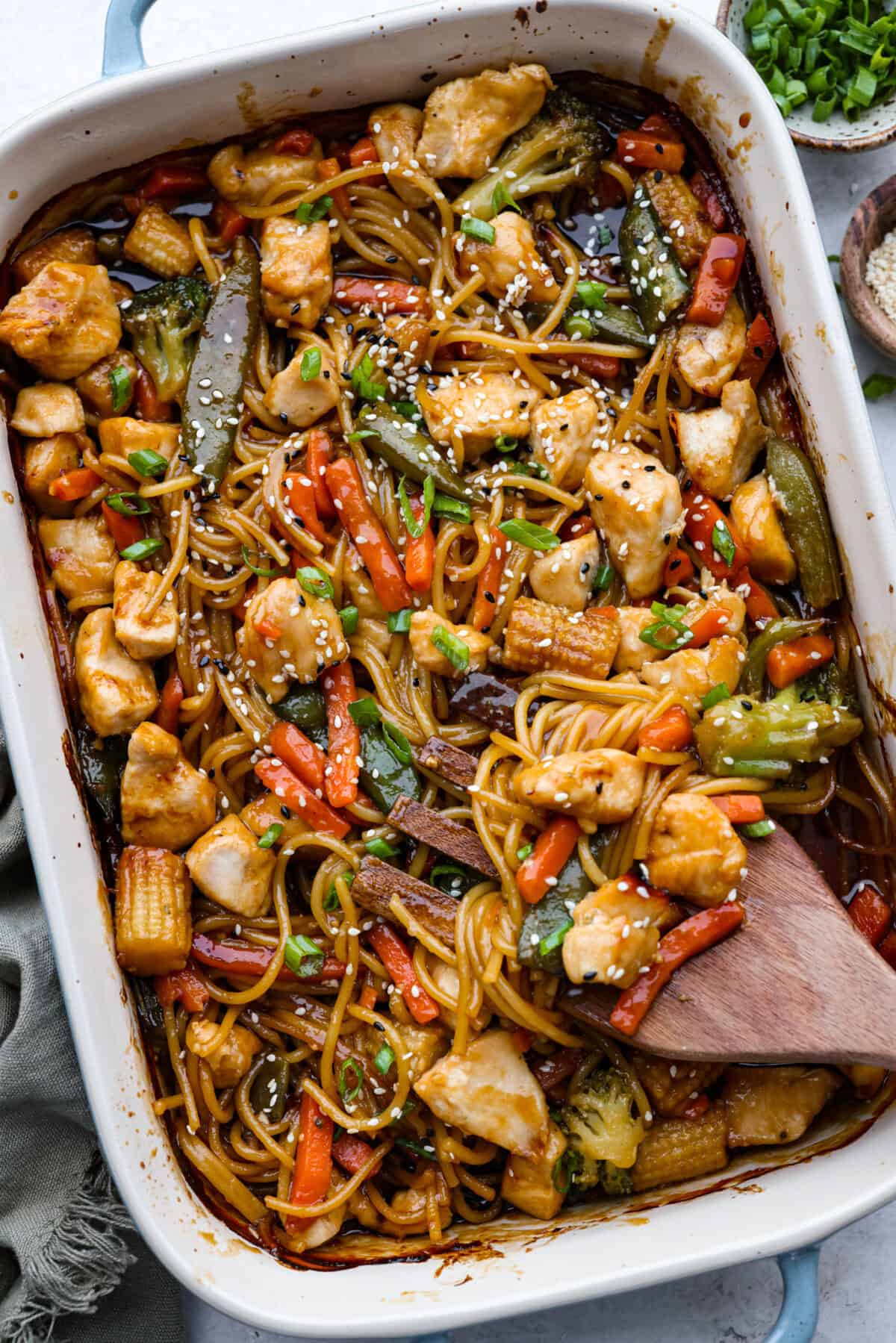Honey Sesame Chicken Noodle Bake is the perfect dinner solution when you need something incredibly tasty and totally fuss-free! This is a complete meal with delicious Asian flavors in one pan, without needing to pre-cook anything. Overhead shot of honey sesame chicken noodle bake.