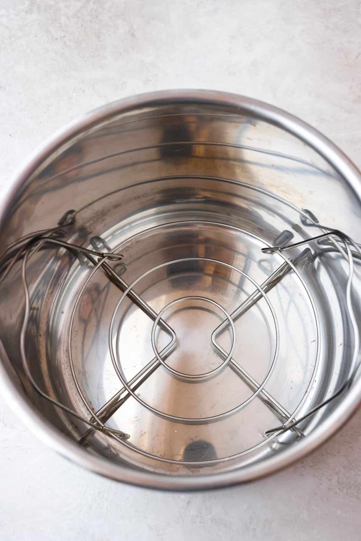 STOP being scared of your Instant Pot! This beginner's guide on How to Use an Instant Pot will help you feel comfortable and confident when using this magical kitchen appliance. It makes cooking fast, easy, and convenient. Fifth photo of the trivet inside the inner pot.