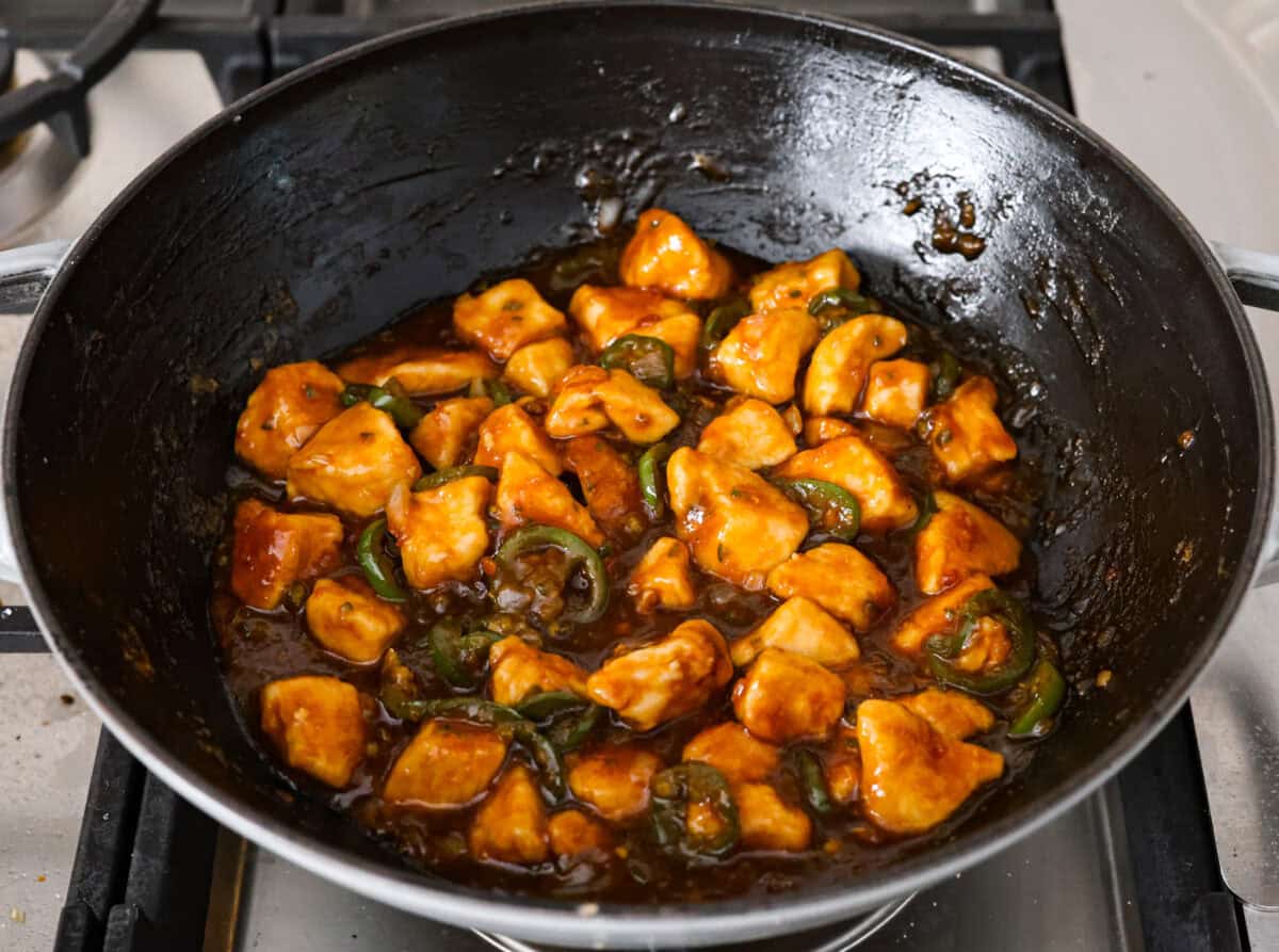 Delicious Jalapeño Chicken will become an instant favorite with the very first bite. Tender chicken pieces are cooked with jalapeños and then coated in a sticky, sweet, and spicy sauce. Serve over rice for an easy meal. You'll be craving it on repeat! Overhead shot of cooked jalapeño chicken in a skillet.
