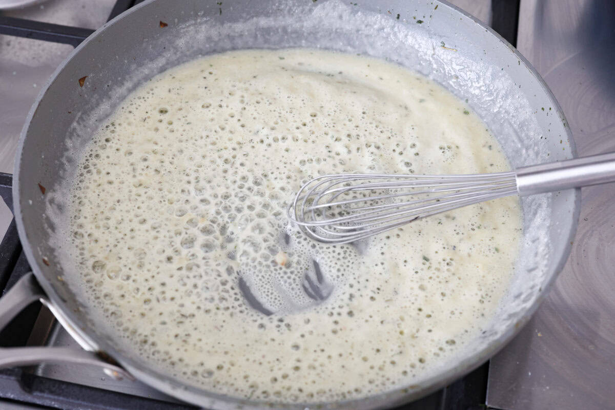 Chicken pot pie casserole is a fun twist on the classic pot pie. It's made with buttery biscuit dough, tender chicken, crunchy veggies, and the most delicious creamy sauce loaded with incredible seasoning. Comfort food at its finest! Overhead shot of butter, and flour being whisked together in a hot skillet.
