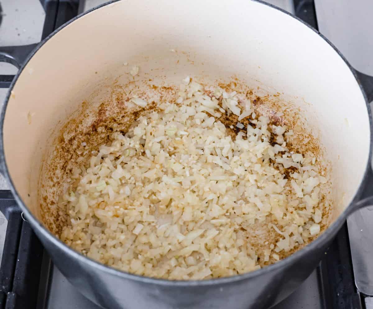 Comforting White Lasagna Soup is warm, creamy, and packed with rich flavors. With its hearty mix of chicken, noodles, white beans, and cheese, it’s a guaranteed crowd-pleaser. Deconstructed white lasagna in a satisfying soup! Overhead shot of onions cooking in a pot.