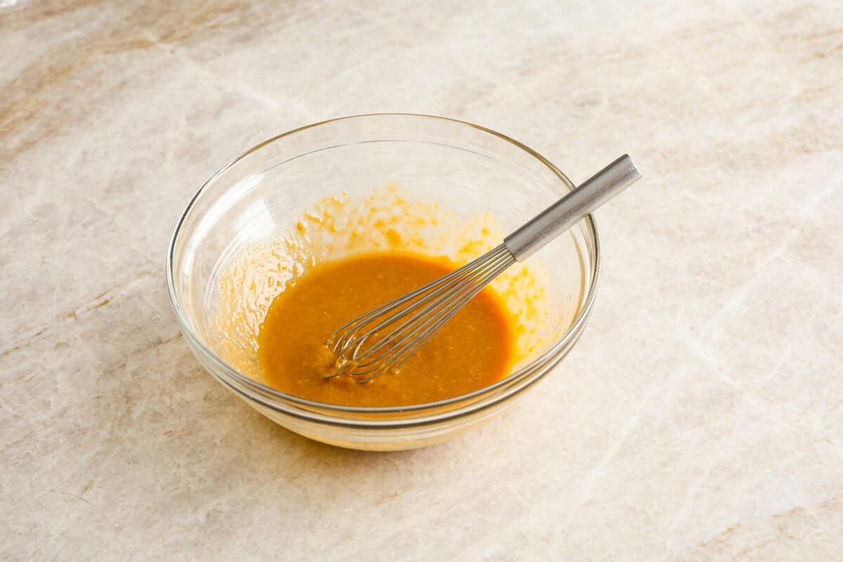 Miso chicken is super delicious and perfect for fans of bold Asian flavor. The skin crisps up, the meat stays juicy and tender, and the glaze caramelizes, creating a savory sauce perfect for drizzling over rice. Angle shot of the marinade ingredients whisked in a bowl.