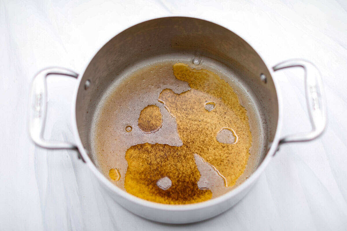 Browned Butter Sheet Cake is the perfect blend of moist, sweet, and irresistibly nutty. With the rich, caramel-like flavor of browned butter baked into every bite, this cake is a treat for anyone who loves a touch of warmth in their desserts. Overhead shot of the butter being melted and browned in a pot for the frosting.