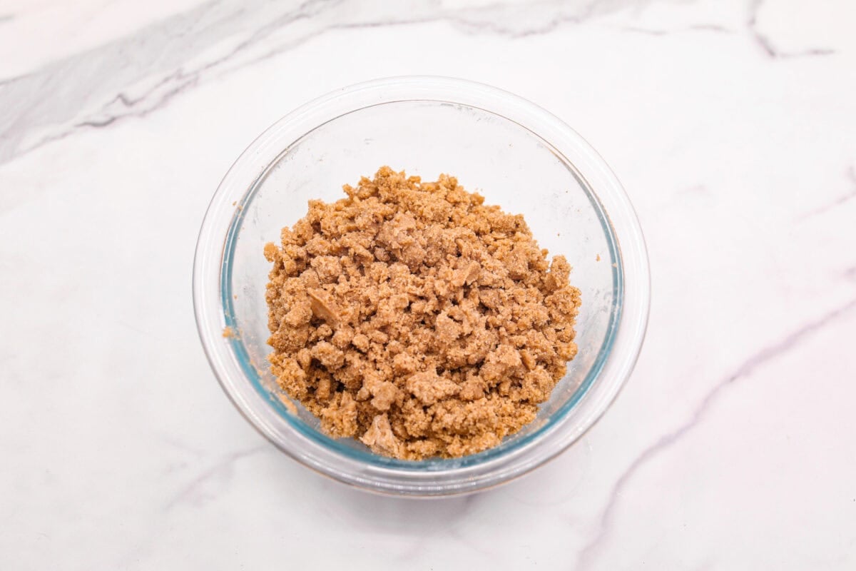 You will absolutely adore these Coffee Cake Cookies! They are loaded with that classic cinnamon sugar flavor, and the crumbly cinnamon streusel is to die for. It’s the perfect treat to enjoy at a special brunch, for the holidays, or a sweet treat for any night of the week. Overhead shot of flour mixture with butter cut in.