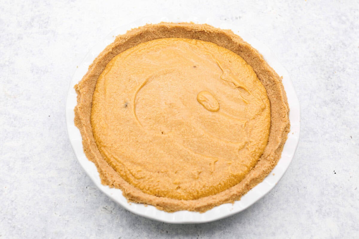 Delicious and addicting, the famous Crack Pie is what made Milk Bar bakery so popular. This copycat recipe is made with a sweet and salty filling tucked inside a crispy oat cookie crust. It’s so good you won’t be able to stop eating it! Overhead shot of crack pie filling in the oatmeal crumb crust in a pie pan.