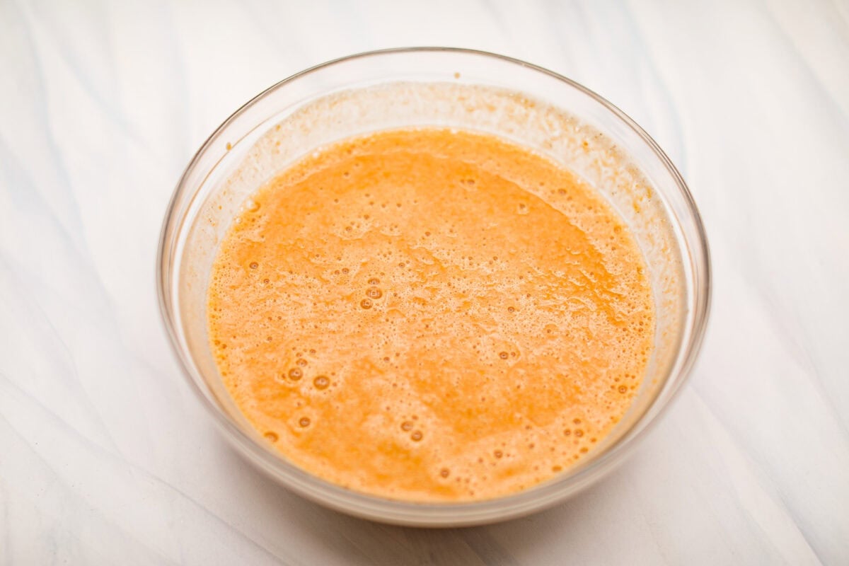Crustless pumpkin pie has rich spices, creamy pumpkin, and a perfectly smooth texture. The custard holds its shape beautifully. Whether you're keeping things simple or exploring a gluten-free option, this pie gives all the nostalgic vibes of the classic. Overhead shot of all the ingredients whisked together in a mixing bowl.