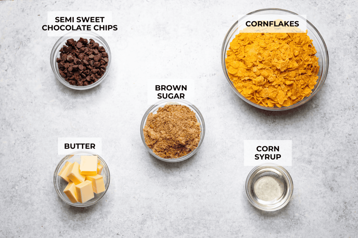 This cornflake brittle crack is crispy, chewy and to die for! With only six ingredients and 8 minutes of prep, you can have this yummy treat ready in no time. This brittle is crunchy cornflakes mixed with a buttery caramel sauce and drizzled in rich dark chocolate. Top shot of all of the ingredients with individual labels.