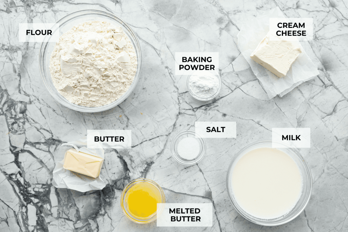 Cream cheese biscuits have a slight twist to the classic version. With the added cream cheese, they have a softer, more fluffy texture with an added tangy flavor that is so good! Overhead shot of labeled ingredients.