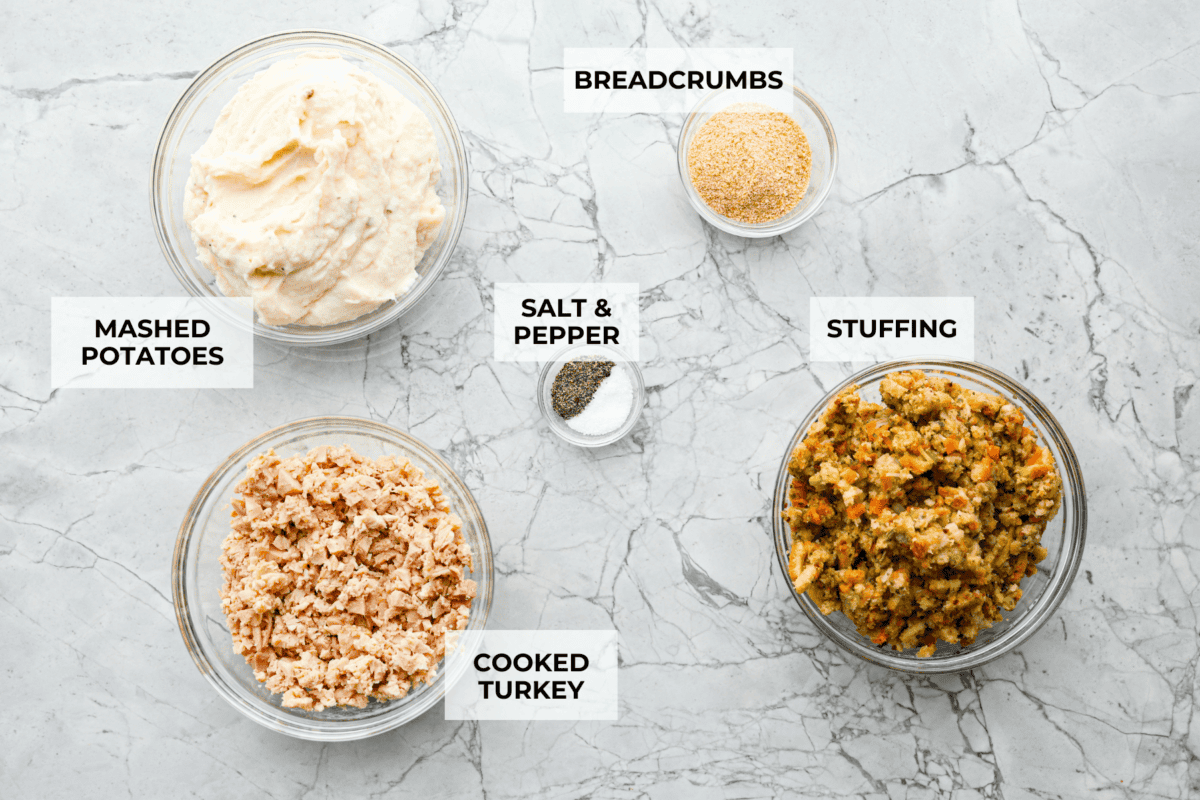 Turkey Stuffing Balls capture the taste of Thanksgiving in a single bite! Made with tender turkey, flavorful stuffing, and mashed potatoes. Theyโre rolled into perfectly poppable bites and served with rich gravy for dipping. Overhead shot of labeled ingredients.