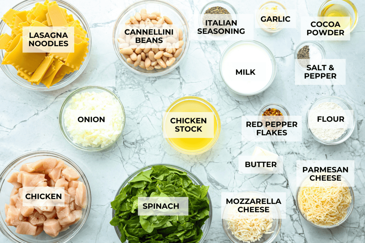 Comforting White Lasagna Soup is warm, creamy, and packed with rich flavors. With its hearty mix of chicken, noodles, white beans, and cheese, it’s a guaranteed crowd-pleaser. Deconstructed white lasagna in a satisfying soup! Overhead shot of labeled ingredients.