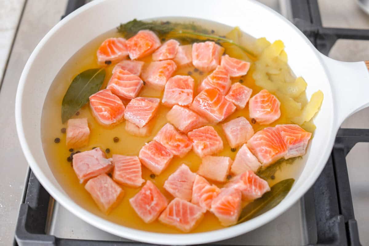 Salmon rillettes is a creamy, flavorful spread made with fresh and smoked salmon blended with lemon, sour cream, and herbs. It is perfect for spreading on crackers or toasted baguette slices. This elegant appetizer is a crowd-pleaser for any occasion! Overhead shot of salmon in the white wine reduction.