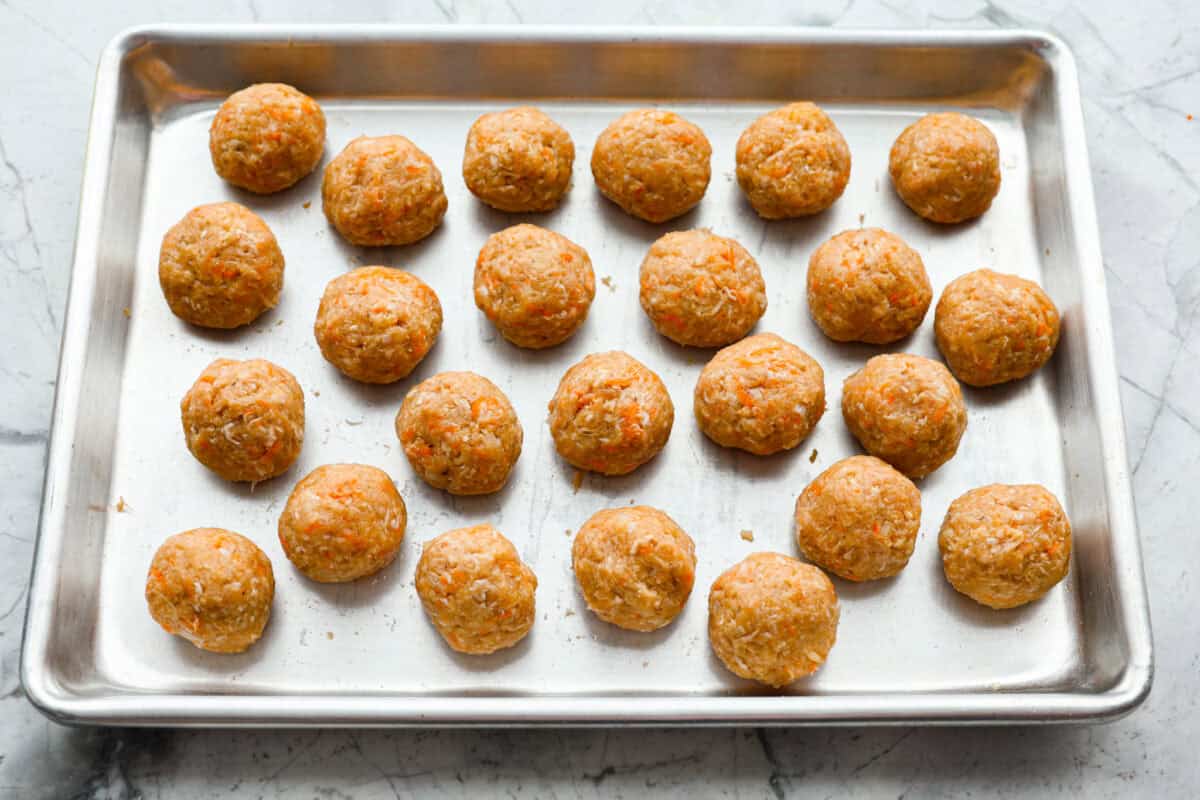 Easy Bola Bola (Filipino meatballs) combine pork, panko breadcrumbs, carrots, and onions to create a versatile meatball recipe. Tender and tasty on the inside then deep-fried and crispy on the outside! The perfect appetizer or dinner idea! Third photo of the meatballs rolled into balls.